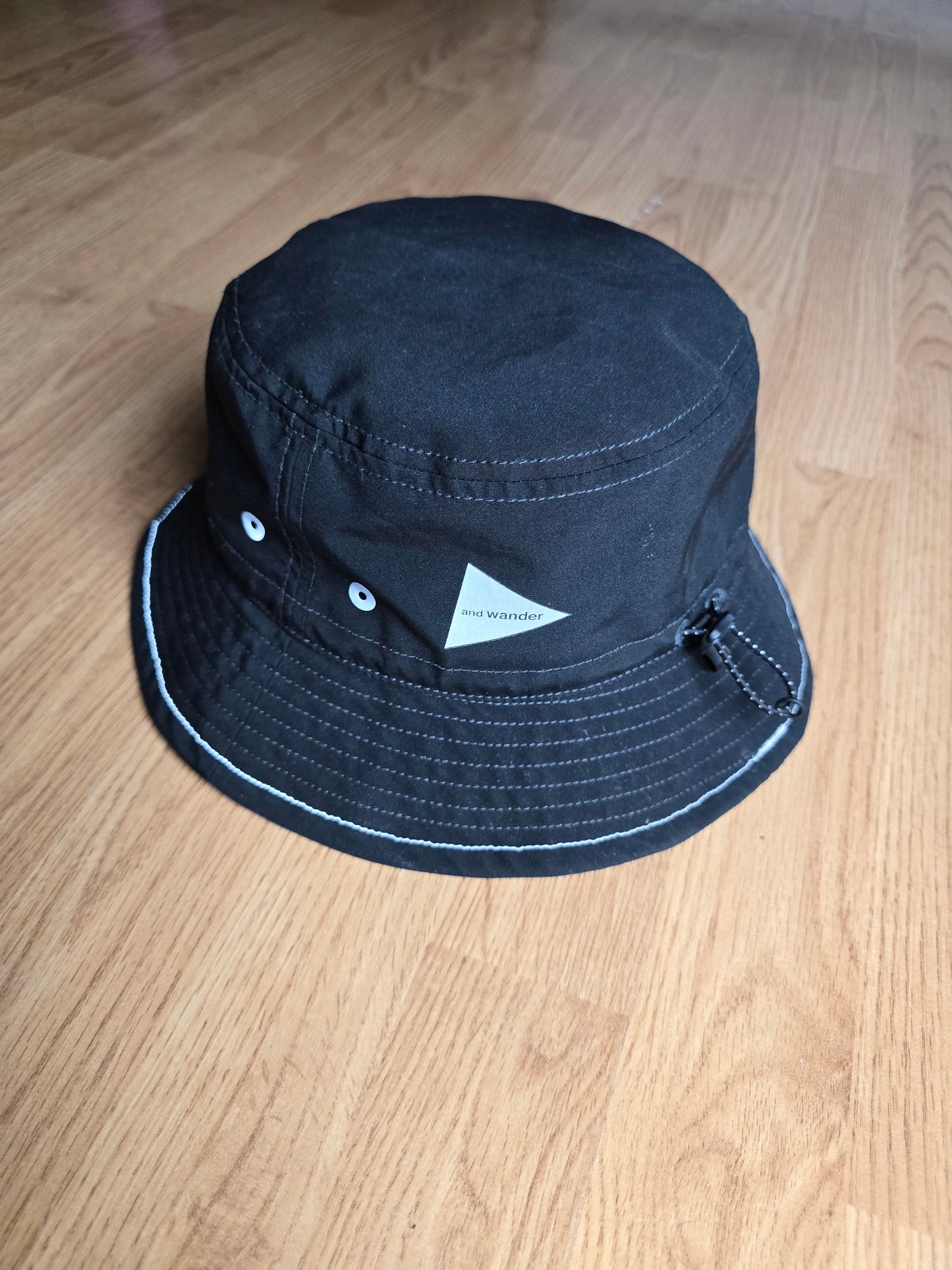 And Wander Logo Print 3M Reflective Bucket Hat